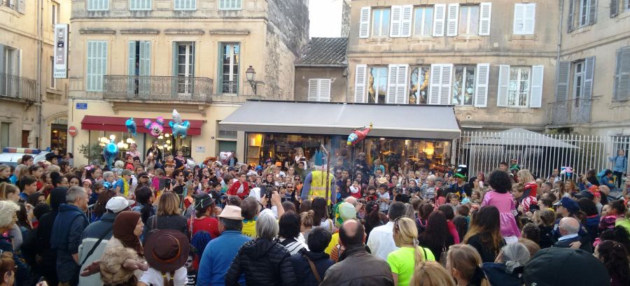 A crowd watches an effigy of winter going up in smoke.